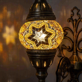 Lit close-up of mosaic glass globe — Amber wall sconce glowing (ENV APN1022)