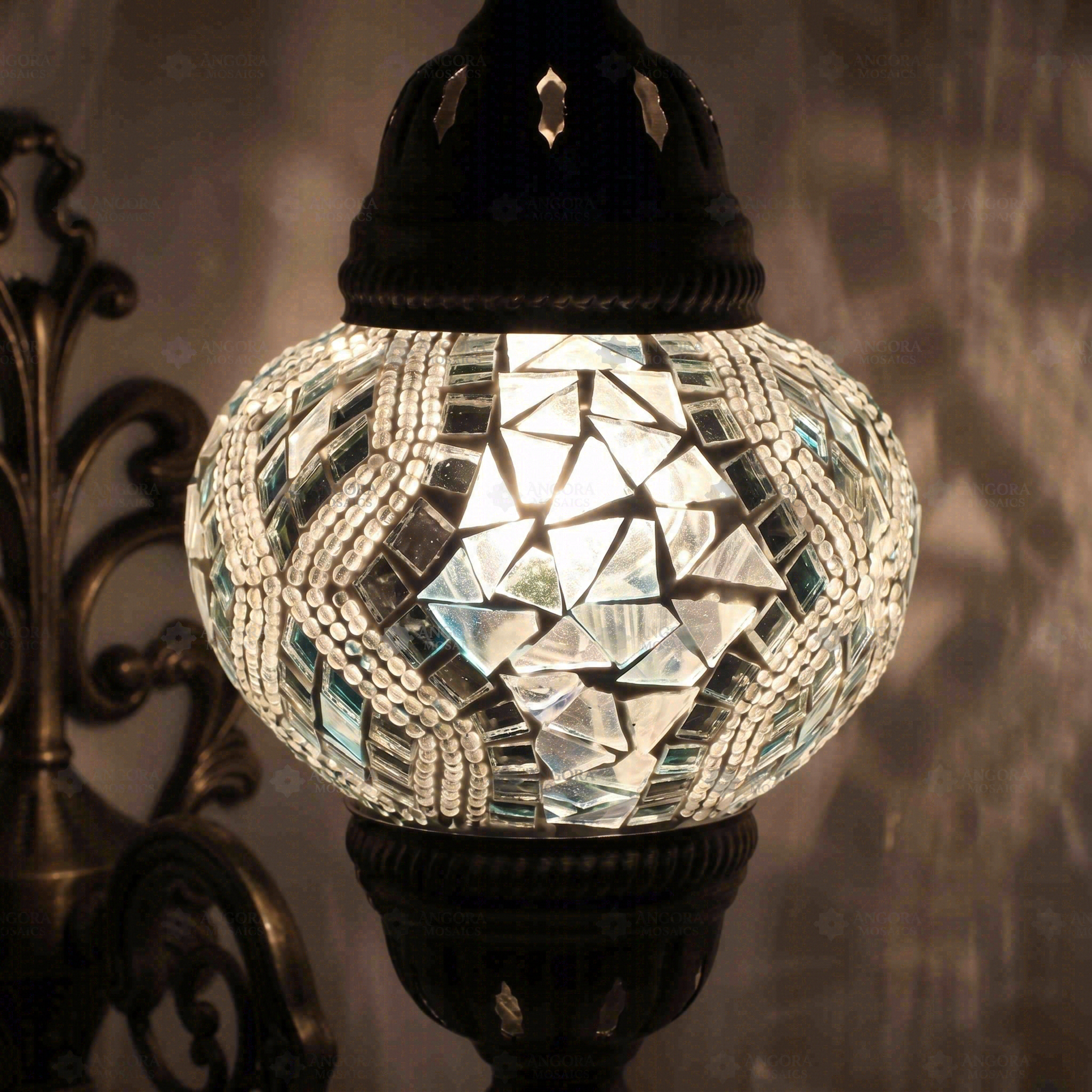 Lit close-up of mosaic glass globe — White wall sconce glowing (ENV APN2017)