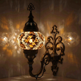 Amber Turkish mosaic wall sconce illuminated, showing colorful light projection (ENV APN2025)