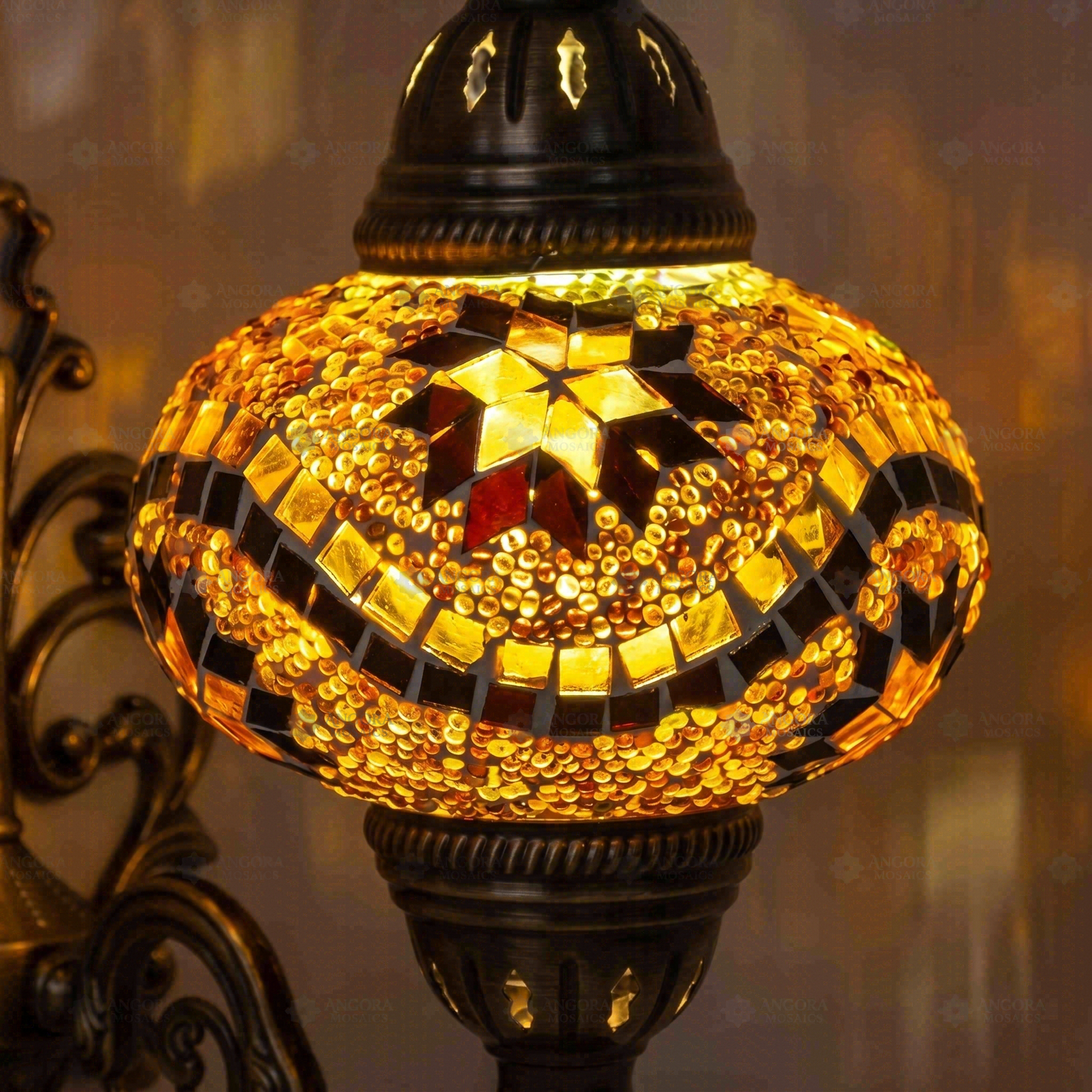 Lit close-up of mosaic glass globe — Amber wall sconce glowing (ENV APN3009)