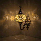 Clear Turkish mosaic wall sconce illuminated, showing colorful light projection (ENV APN3015)