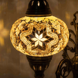 Lit close-up of mosaic glass globe — Clear wall sconce glowing (ENV APN3015)