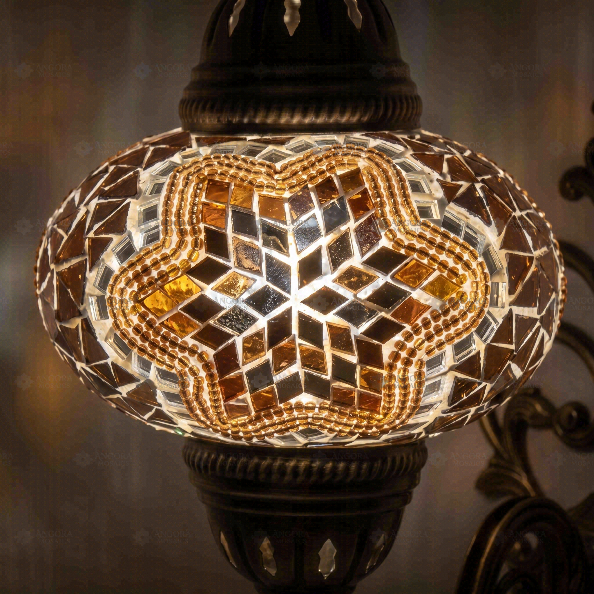 Lit close-up of mosaic glass globe — Warm Tones wall sconce glowing (ENV APN3019)