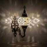 White Turkish mosaic wall sconce illuminated, showing colorful light projection (ENV APN3023)