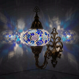Blue Turkish mosaic wall sconce illuminated, showing colorful light projection (ENV APN3028)