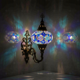 Blue Turkish mosaic wall sconce illuminated, showing colorful light projection (ENV APN3032)