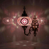 Pink Turkish mosaic wall sconce illuminated, showing colorful light projection (ENV APN3044)