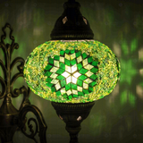 Lit close-up of mosaic glass globe — Green wall sconce glowing (ENV APN3048)