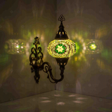 Green Turkish mosaic wall sconce illuminated, showing colorful light projection (ENV APN3050)