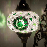 Lit close-up of mosaic glass globe — Green wall sconce glowing (ENV APN3055)