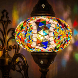 Lit close-up of mosaic glass globe — Multicolor wall sconce glowing (ENV APN3060)