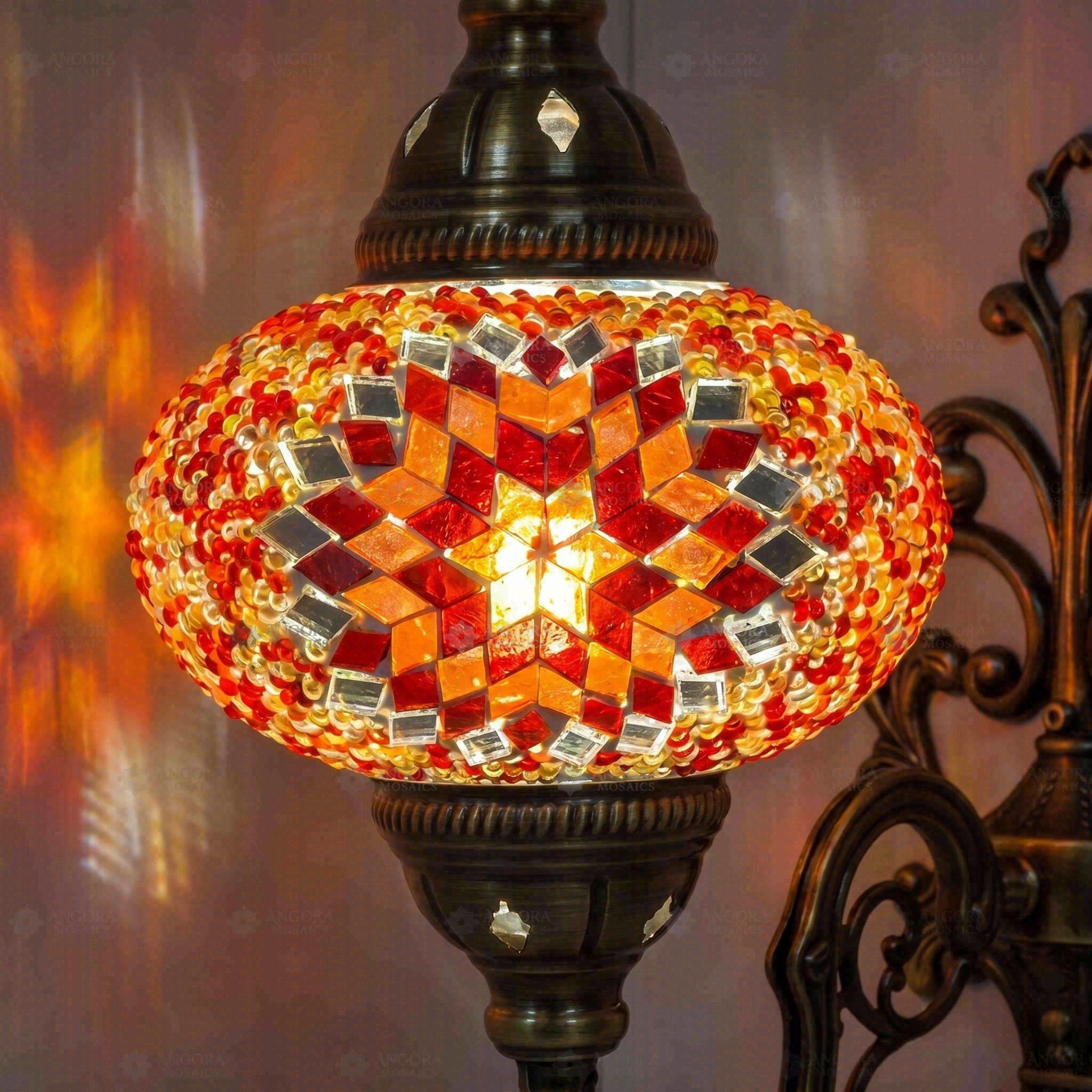 Lit close-up of mosaic glass globe — Amber wall sconce glowing (ENV APN3065)