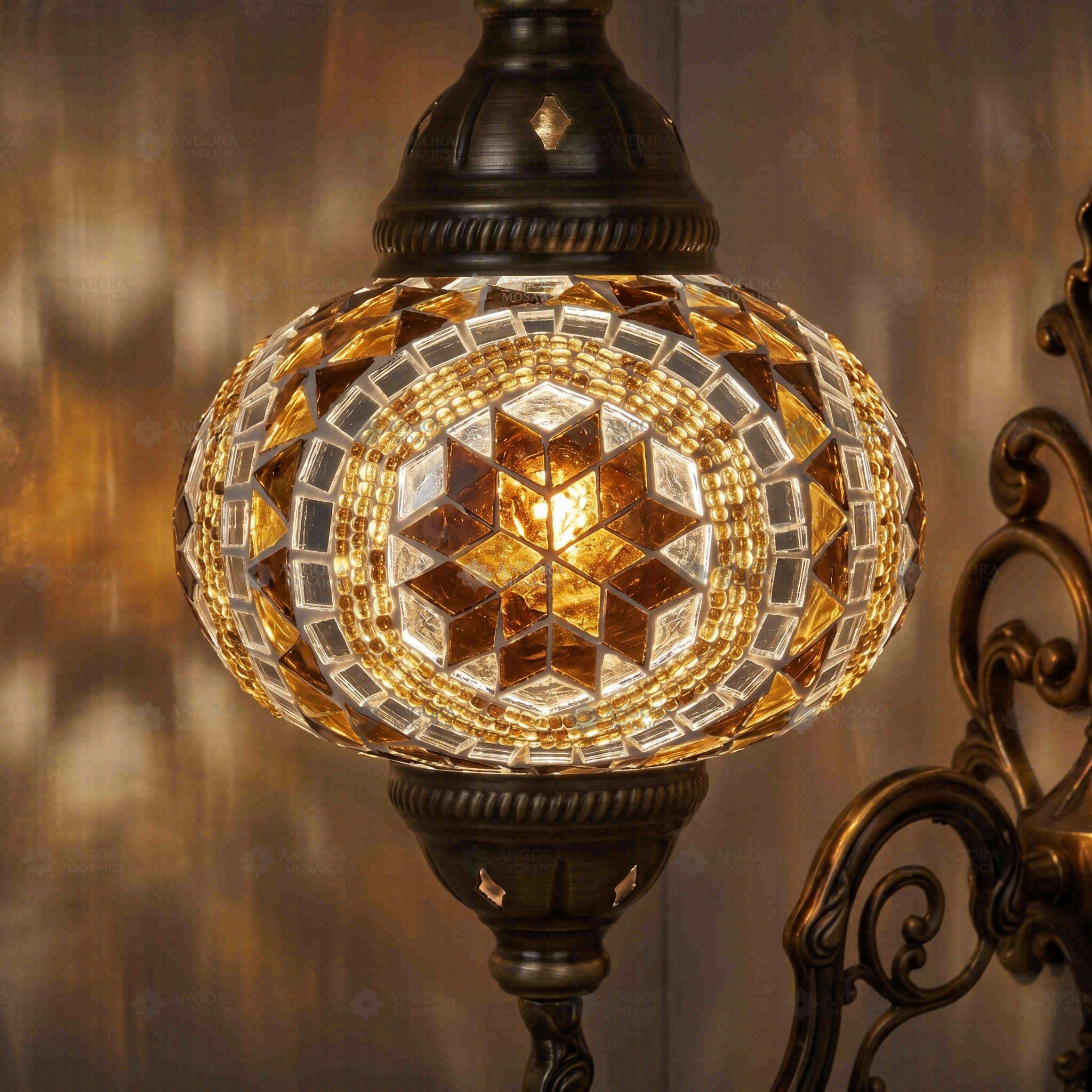 Lit close-up of mosaic glass globe — Amber wall sconce glowing (ENV APN3067)