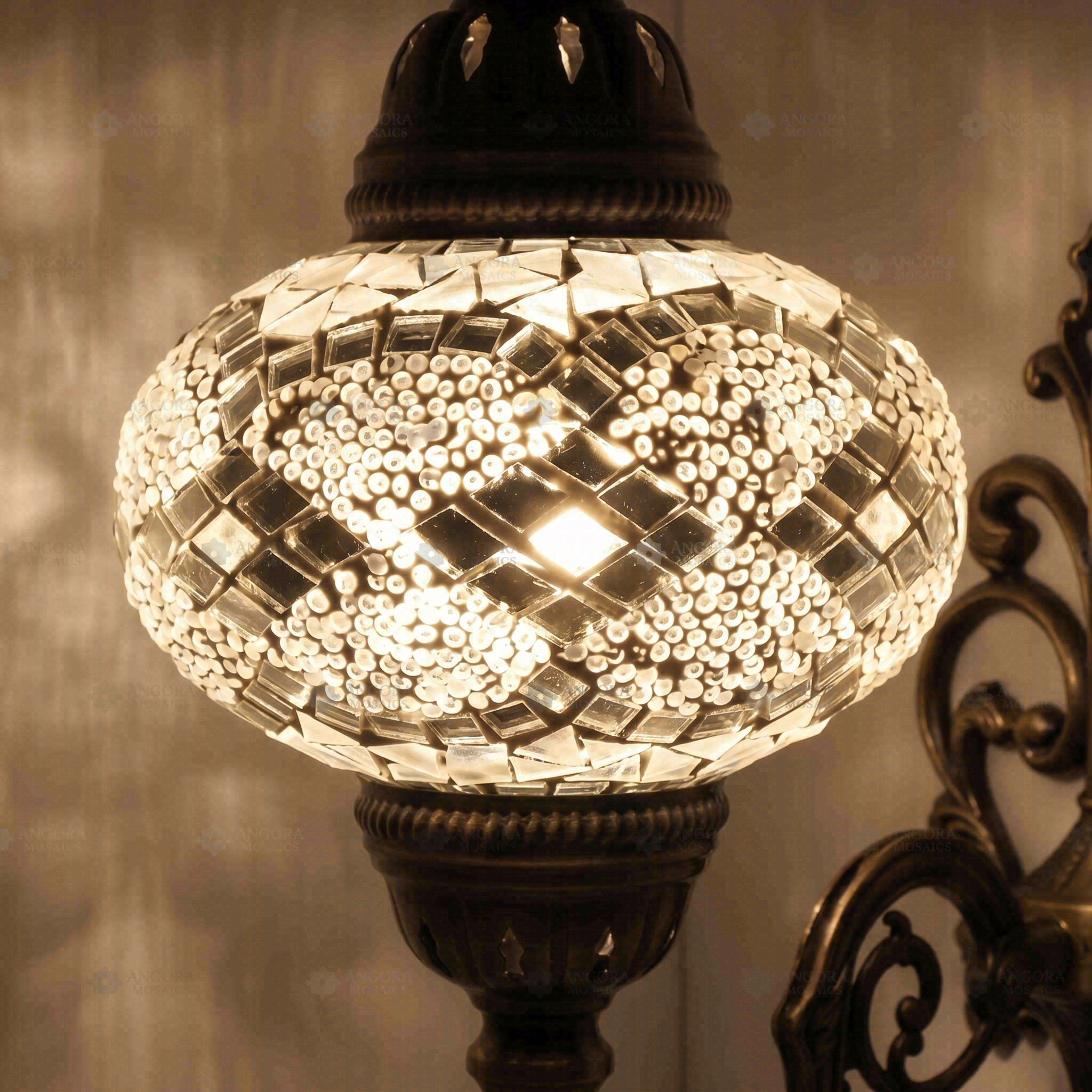 Lit close-up of mosaic glass globe — White wall sconce glowing (ENV APN3068)