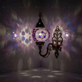 Purple Turkish mosaic wall sconce illuminated, showing colorful light projection (ENV APN3087)
