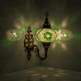 Green Turkish mosaic wall sconce illuminated, showing colorful light projection (ENV APN3096)