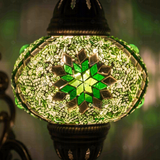 Lit close-up of mosaic glass globe — Green wall sconce glowing (ENV APN3096)