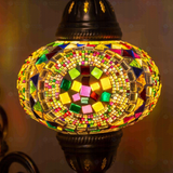 Lit close-up of mosaic glass globe — Multicolor wall sconce glowing (ENV APN3099)