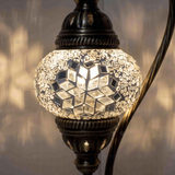 Lit close-up of mosaic glass globe — White table lamp glowing (ENV DVN1001)