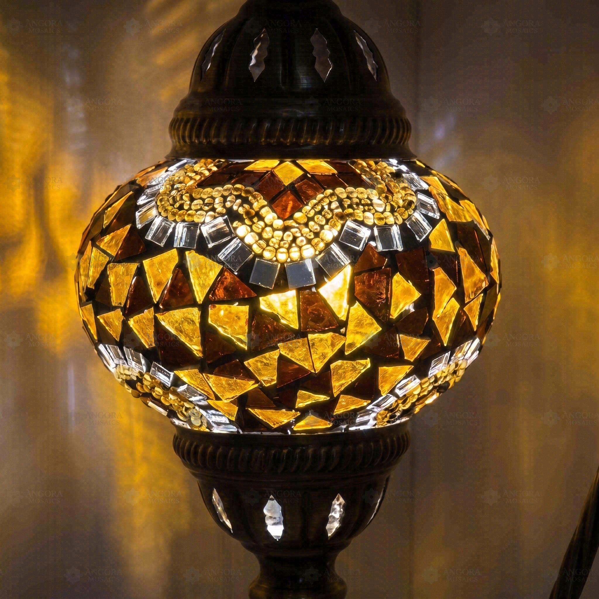 Lit close-up of mosaic glass globe — Amber table lamp glowing (ENV DVN2079)
