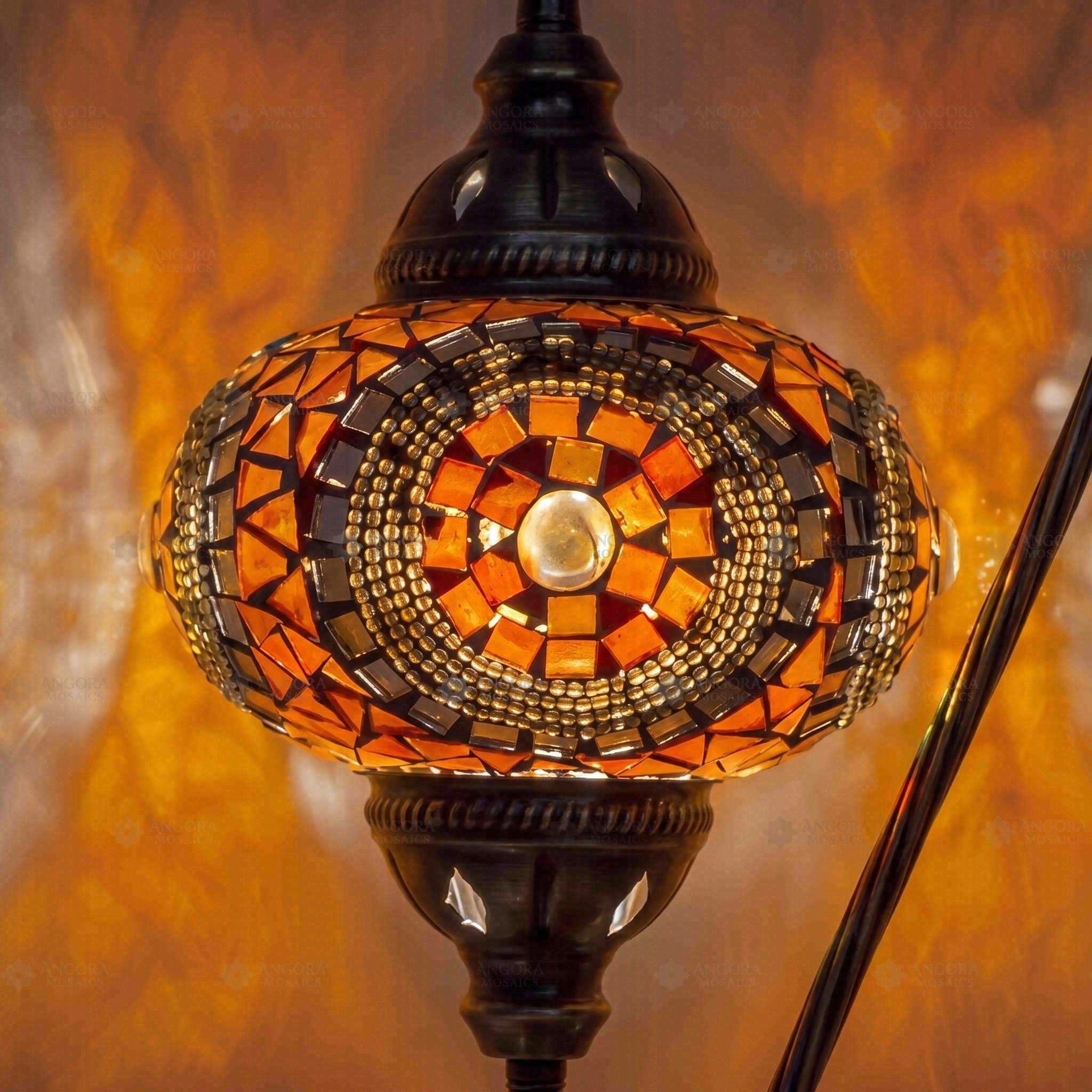 Lit close-up of mosaic glass globe — Amber table lamp glowing (ENV DVN3052)