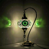 Green Turkish mosaic table lamp illuminated, showing colorful light projection (ENV DVN3055)