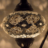 Lit close-up of mosaic glass globe — White table lamp glowing (ENV DVN3068)