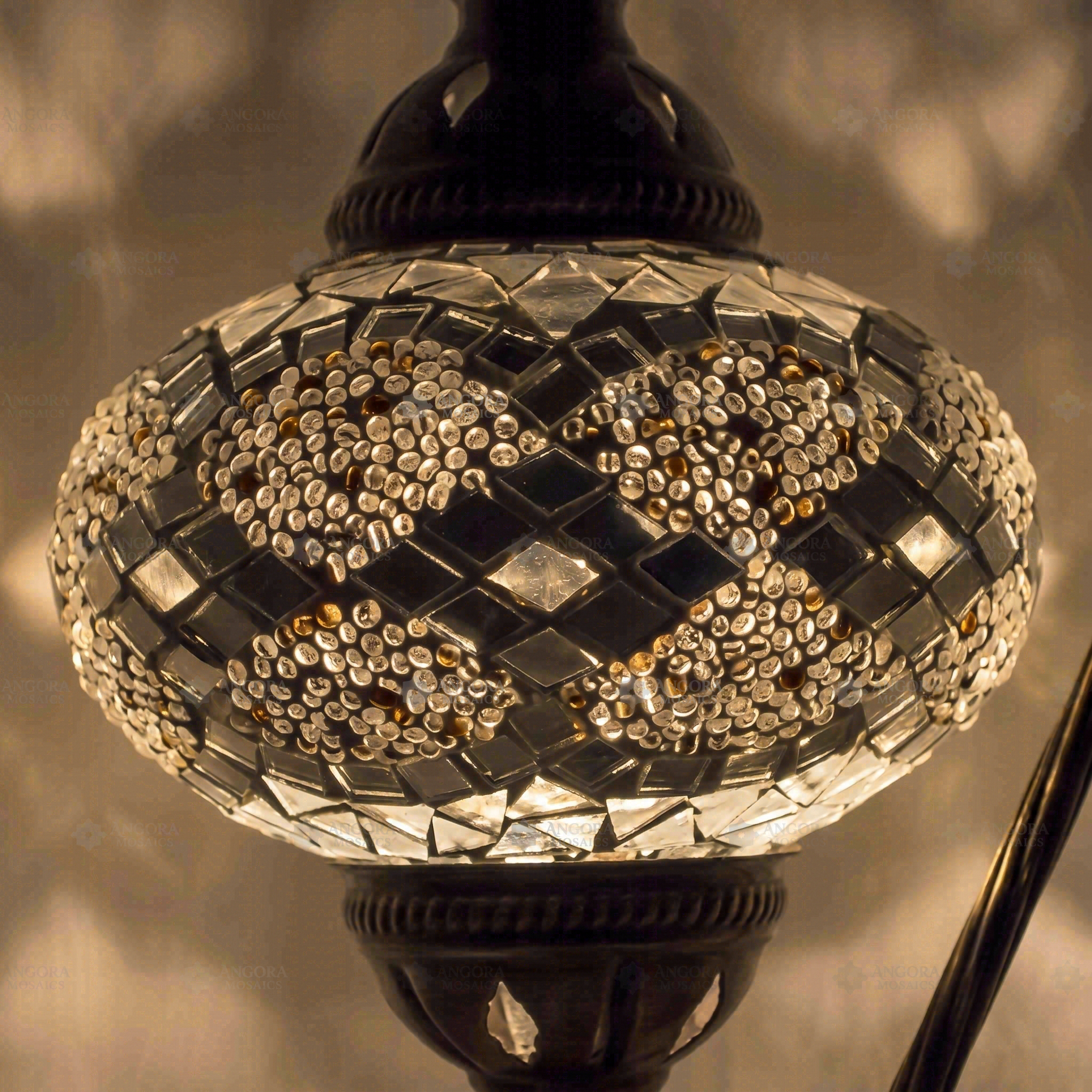 Lit close-up of mosaic glass globe — White table lamp glowing (ENV DVN3068)