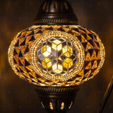 Lit close-up of mosaic glass globe — Amber table lamp glowing (ENV DVN3089)