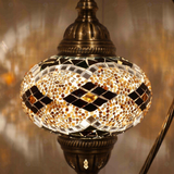 Lit close-up of mosaic glass globe — Amber table lamp glowing (ENV DVN3092)