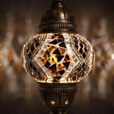 Lit close-up of mosaic glass globe — Clear pendant light glowing (ENV DYN2025)
