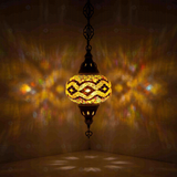 Amber Turkish mosaic pendant light illuminated, showing colorful light projection (ENV DYN3013)