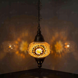 Amber Turkish mosaic pendant light illuminated, showing colorful light projection (ENV DYN3026)
