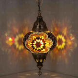 Amber Turkish mosaic pendant light illuminated, showing colorful light projection (ENV DYN3031)