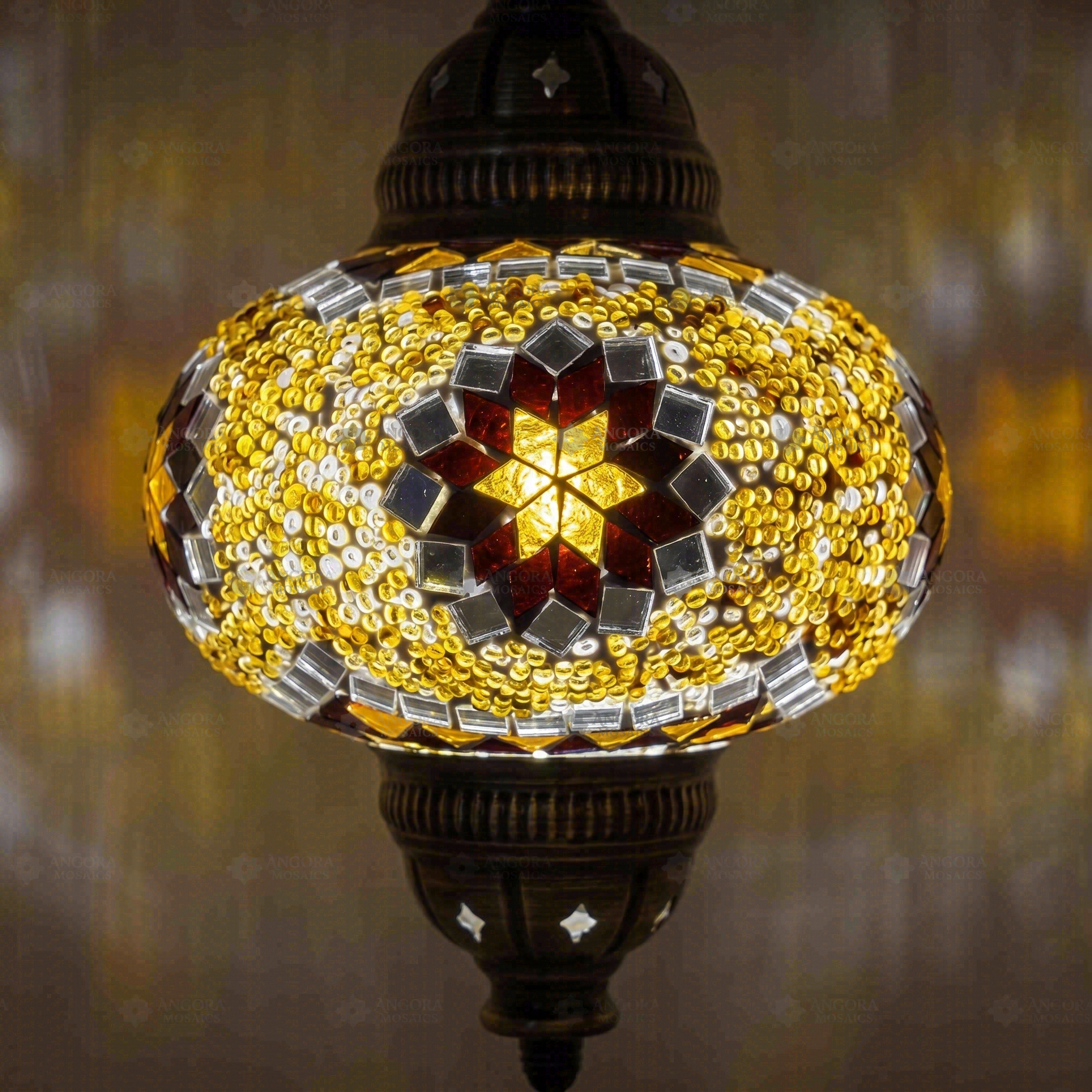 Lit close-up of mosaic glass globe — Amber pendant light glowing (ENV DYN3049)