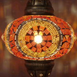 Lit close-up of mosaic glass globe — Amber pendant light glowing (ENV DYN3052)