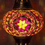 Lit close-up of mosaic glass globe — Amber pendant light glowing (ENV DYN3056)