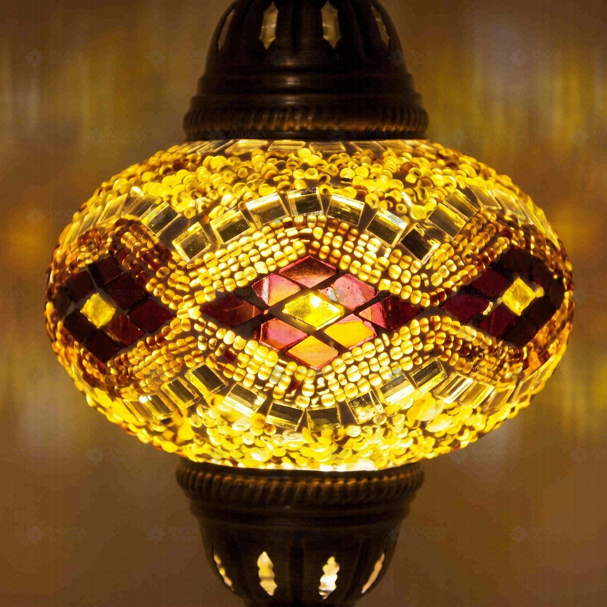 Lit close-up of mosaic glass globe — Amber pendant light glowing (ENV DYN3057)