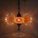 Amber Turkish mosaic pendant light illuminated, showing colorful light projection (ENV DYN3065)