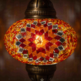 Lit close-up of mosaic glass globe — Amber pendant light glowing (ENV DYN3065)