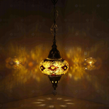 Amber Turkish mosaic pendant light illuminated, showing colorful light projection (ENV DYN3092)