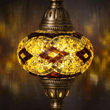 Lit close-up of mosaic glass globe — Amber pendant light glowing (ENV DYN3092)