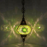 Green Turkish mosaic pendant light illuminated, showing colorful light projection (ENV DYN3096)