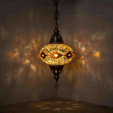 Amber Turkish mosaic pendant light illuminated, showing colorful light projection (ENV DYN3097)