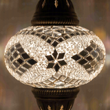 Lit close-up of mosaic glass globe — White pendant light glowing (ENV DYN3098)