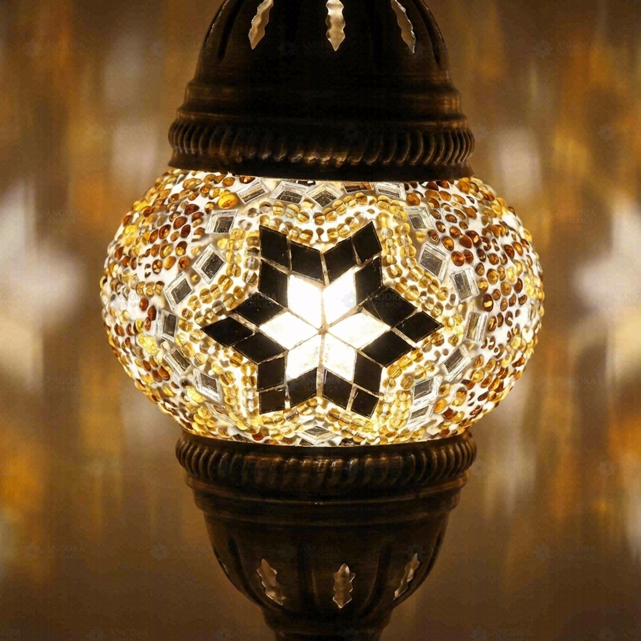 Lit close-up of mosaic glass globe — Amber table lamp glowing (ENV MUN1022)
