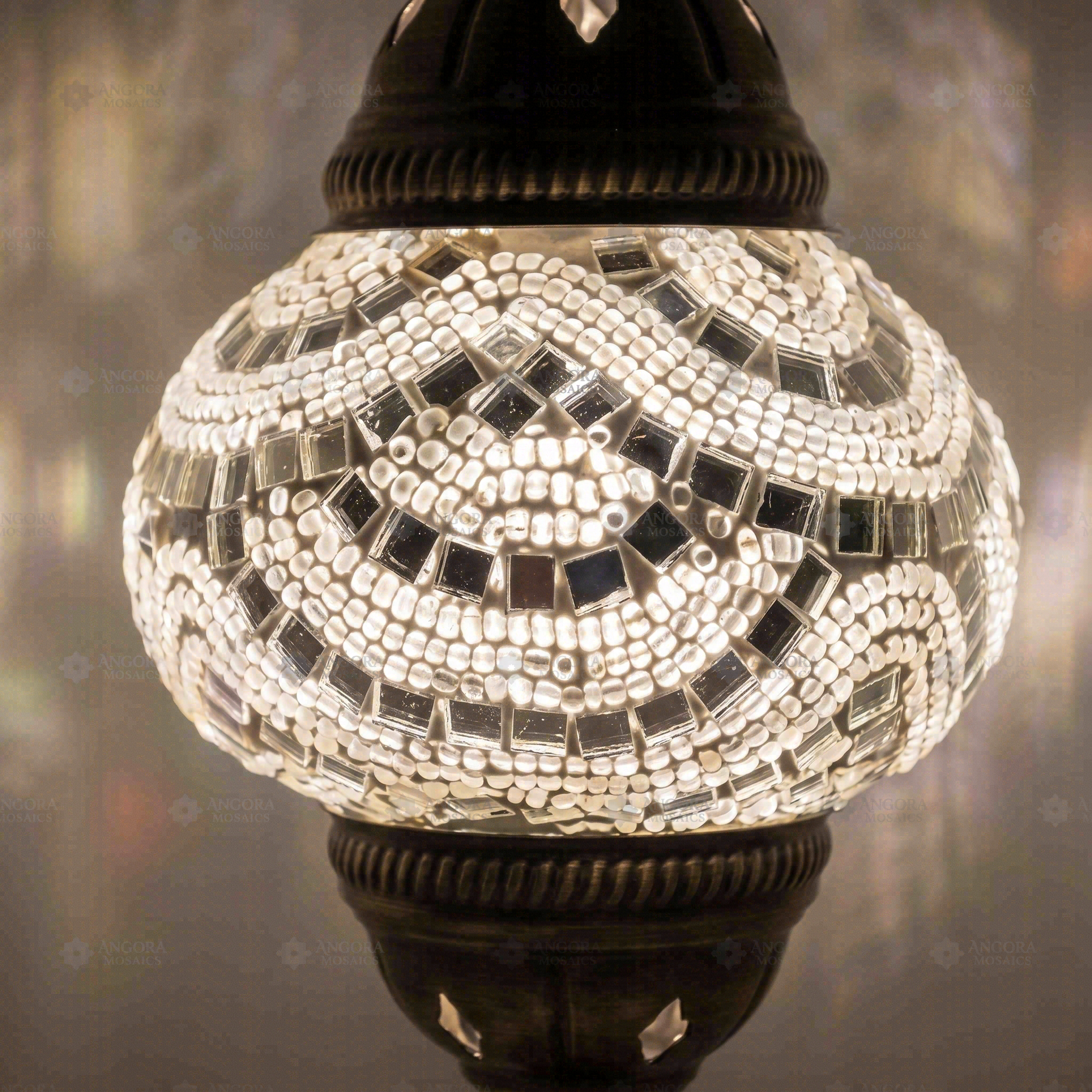 Lit close-up of mosaic glass globe — White table lamp glowing (ENV MUN2001)