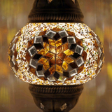 Lit close-up of mosaic glass globe — Amber table lamp glowing (ENV MUN2118)