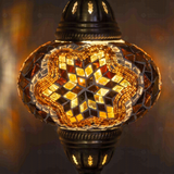 Lit close-up of mosaic glass globe — Amber table lamp glowing (ENV MUN3031)