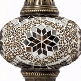 Close-up of Amber warm amber mosaic glass globe pattern — table lamp (ENV MUN3049)